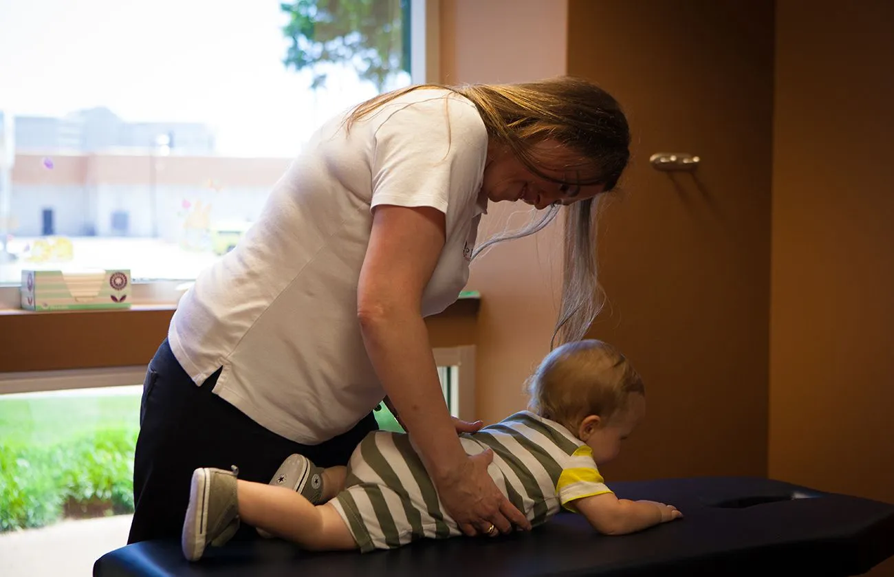 Dr. Calaway adjusting a baby