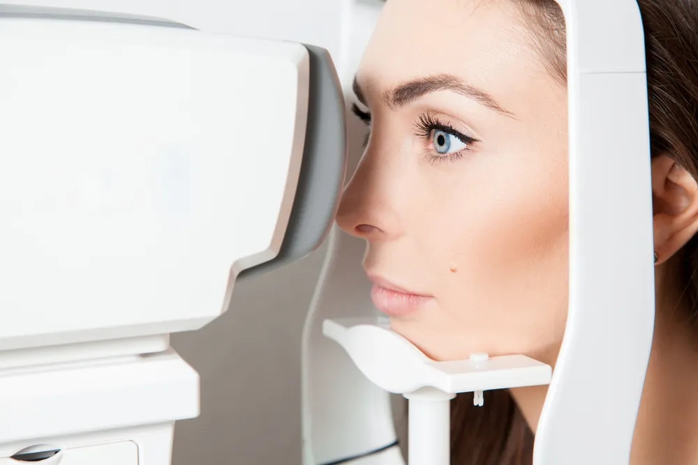 woman receiving an exam from her eye doctor