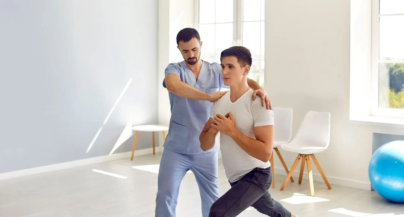 Patient and his therapist doing exercise