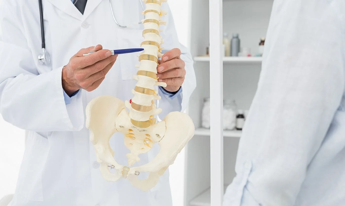 Chiropractor talking to patient about spinal stenosis