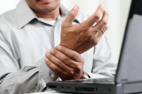 man suffering from chronic pain in his wrist