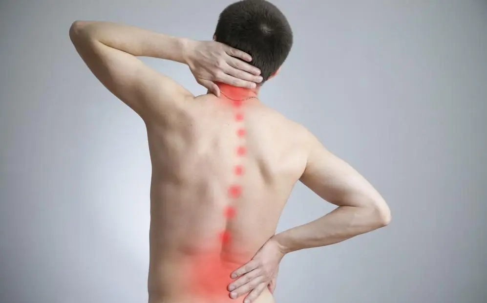 man with back pain before seeing a chiropractor in Clayton