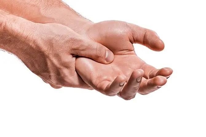 A person that have a carpal pain holding his hand | Carpal Tunnel Treatment in Kenosha