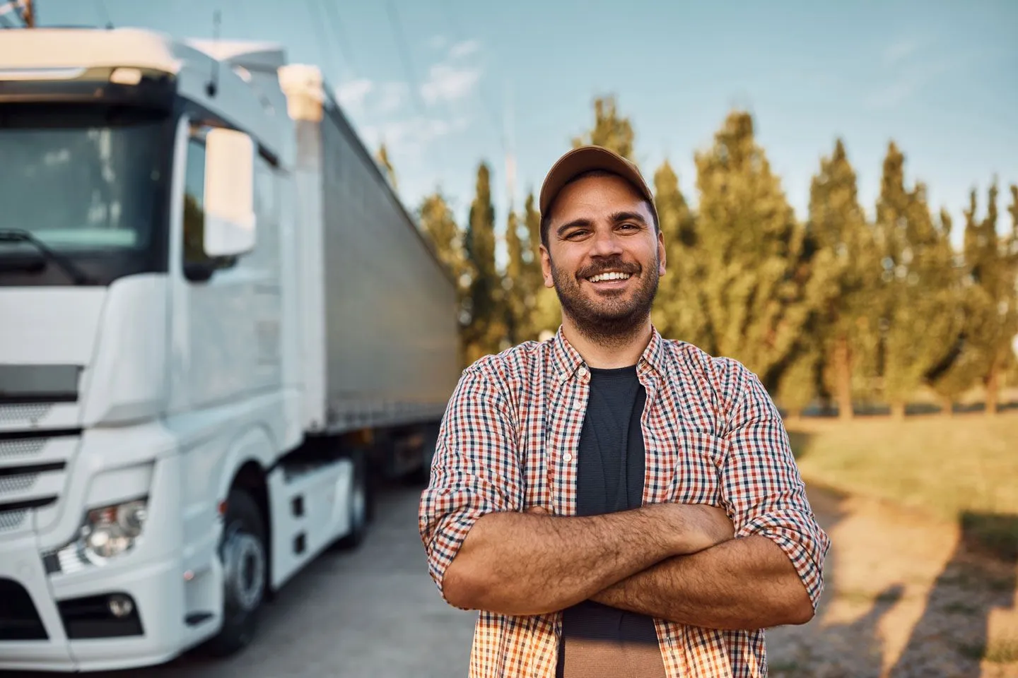 man standing next to semi truck