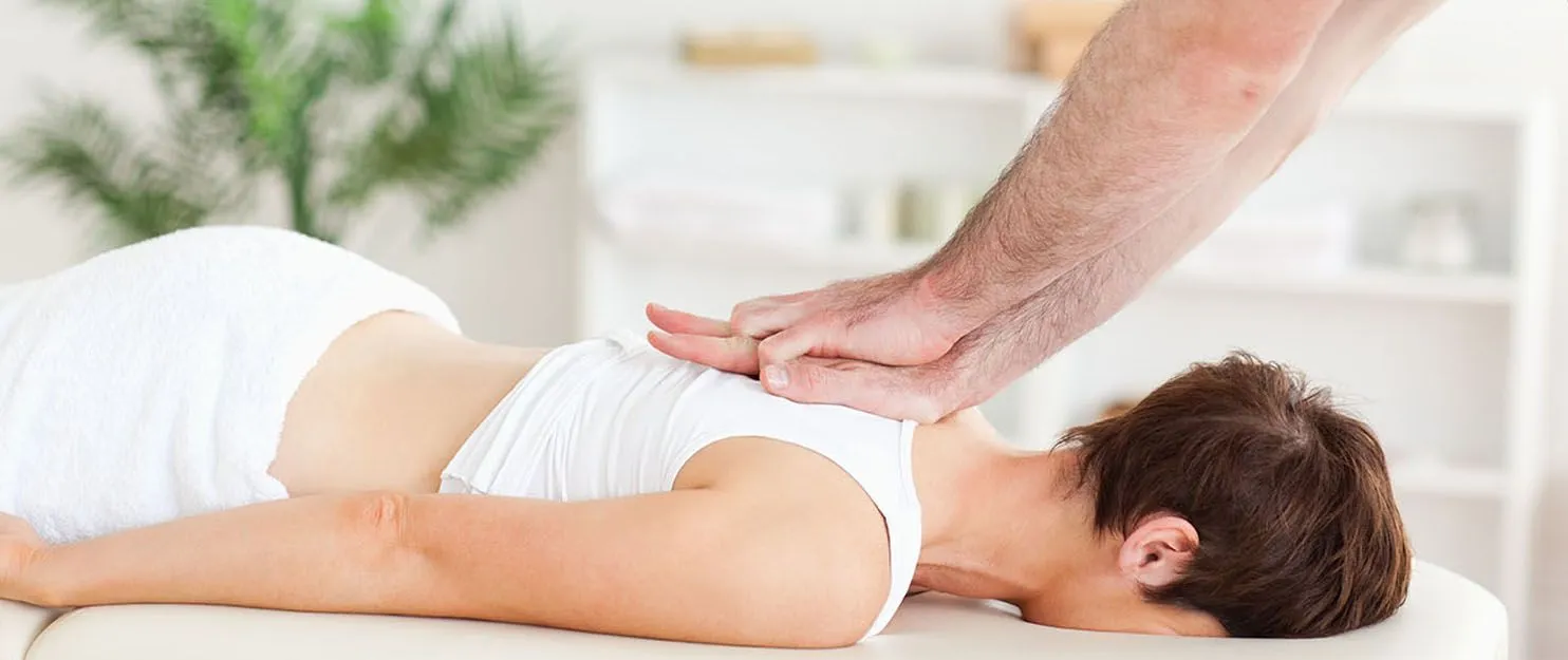 Woman getting chiropractic care in Kenosha.