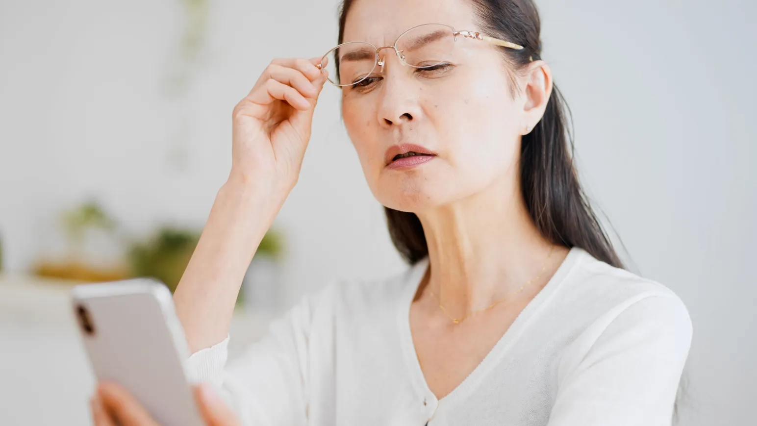 woman reading far in her phone