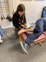 Dr. Sarah performing shockwave therapy