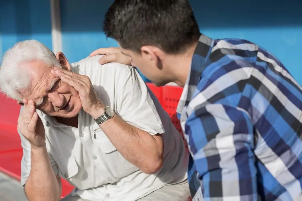 man having a migraine during day