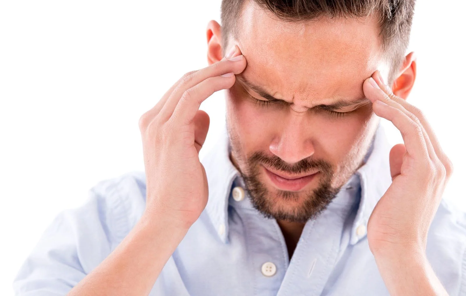 man holding the sides of his head from headache and migraine pain