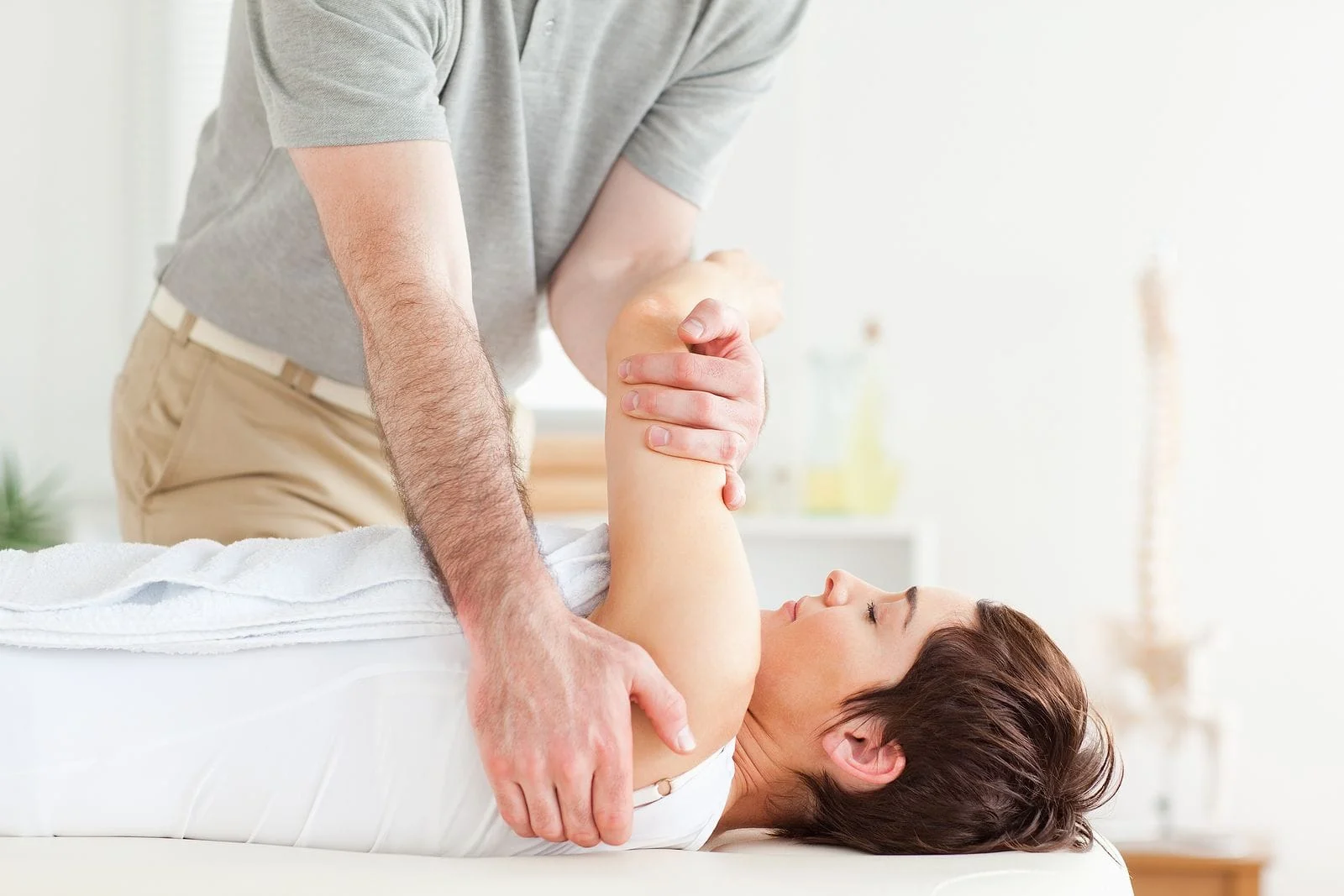 Man stretching a womans arm