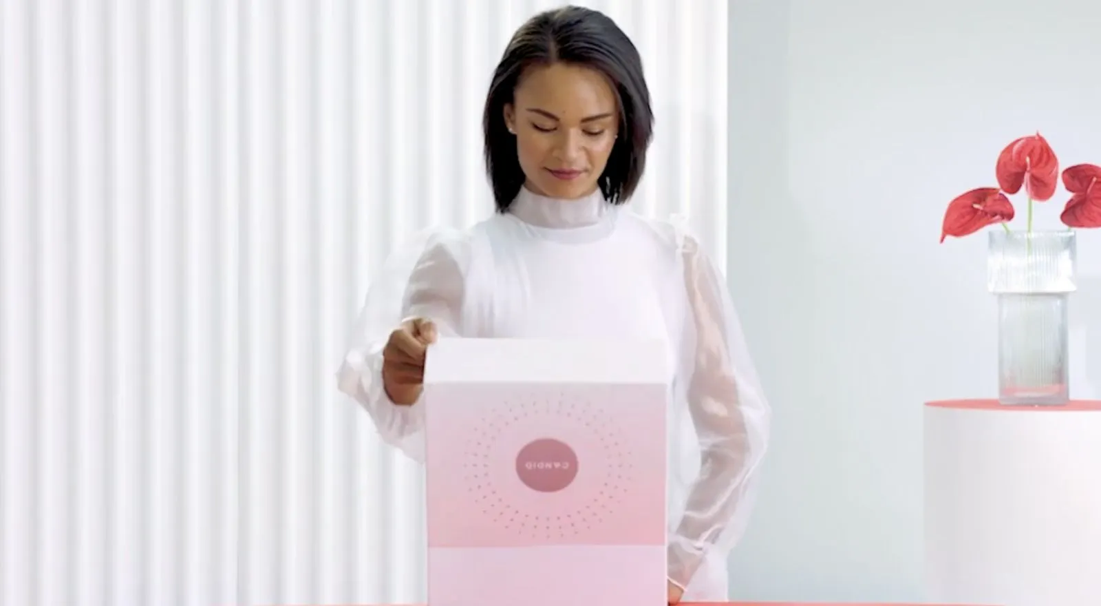 woman opening box with Candid Pro Clear Aligner trays inside, clear aligners - Bucktown dentist, Wicker Park Chicago