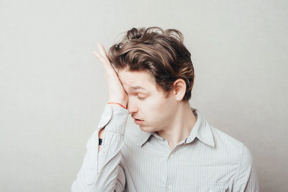 Man covering one eye