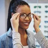 A woman tries on glasses