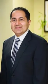 Dr. Amir Sarkarzadeh wearing suit and tie, endodontist Germantown, MD