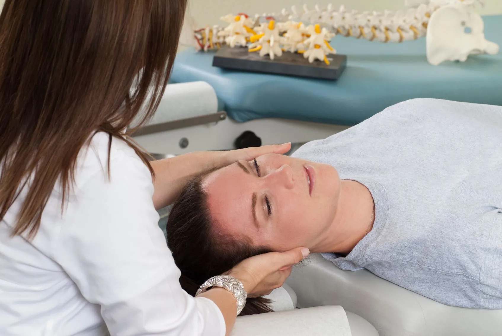 woman getting chiropractic adjustment in Dallas, TX