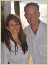 Drs. Elisha and Leslie Van Deusen, D.C. Standing at the Beach in White Clothing