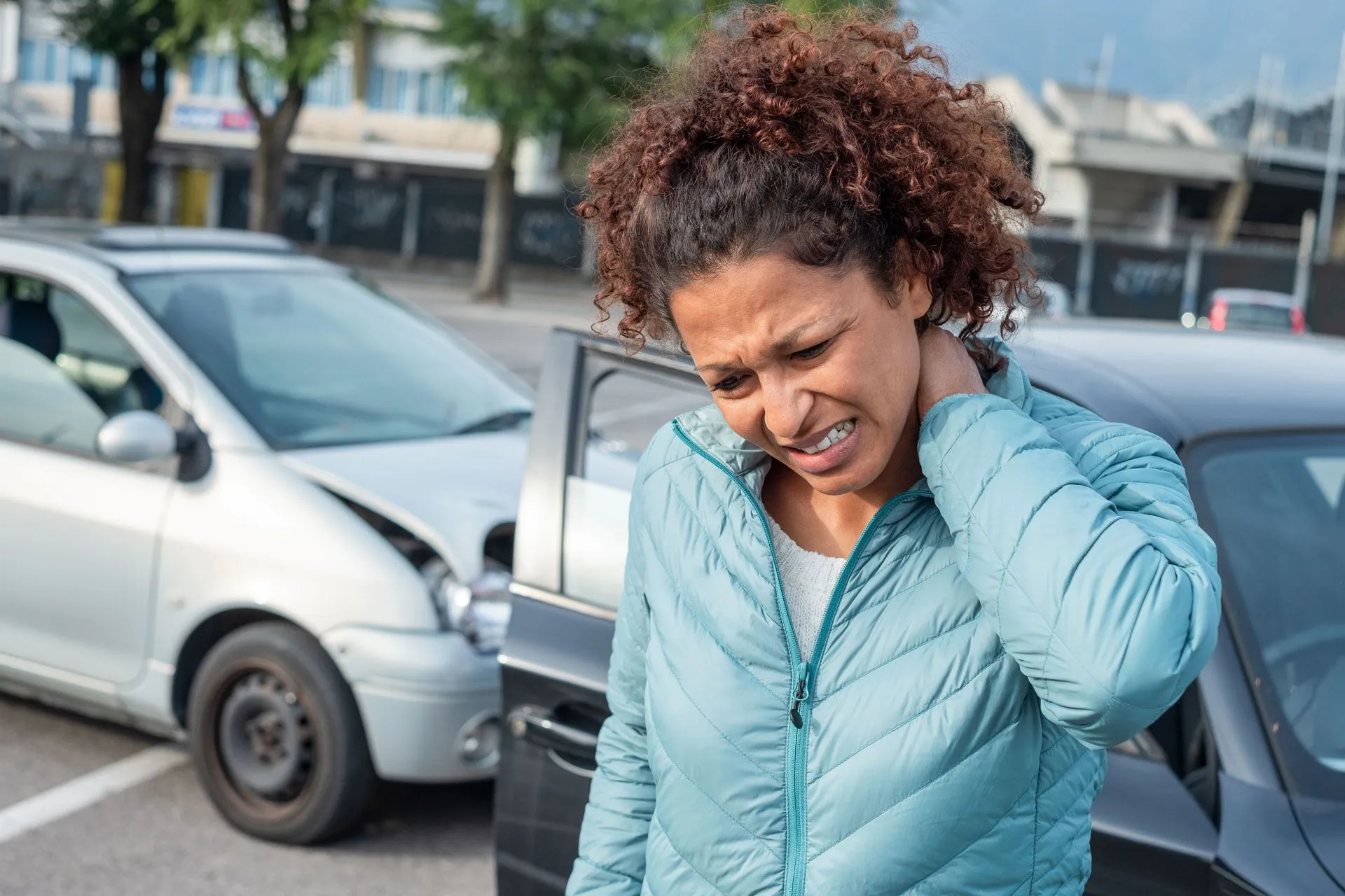 woman holding neck by car accident