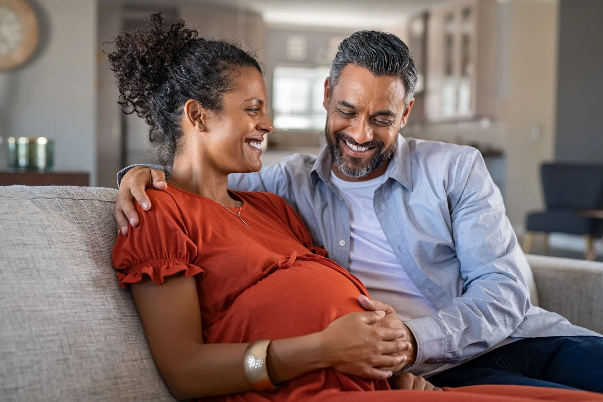 man sitting with pregnant woman