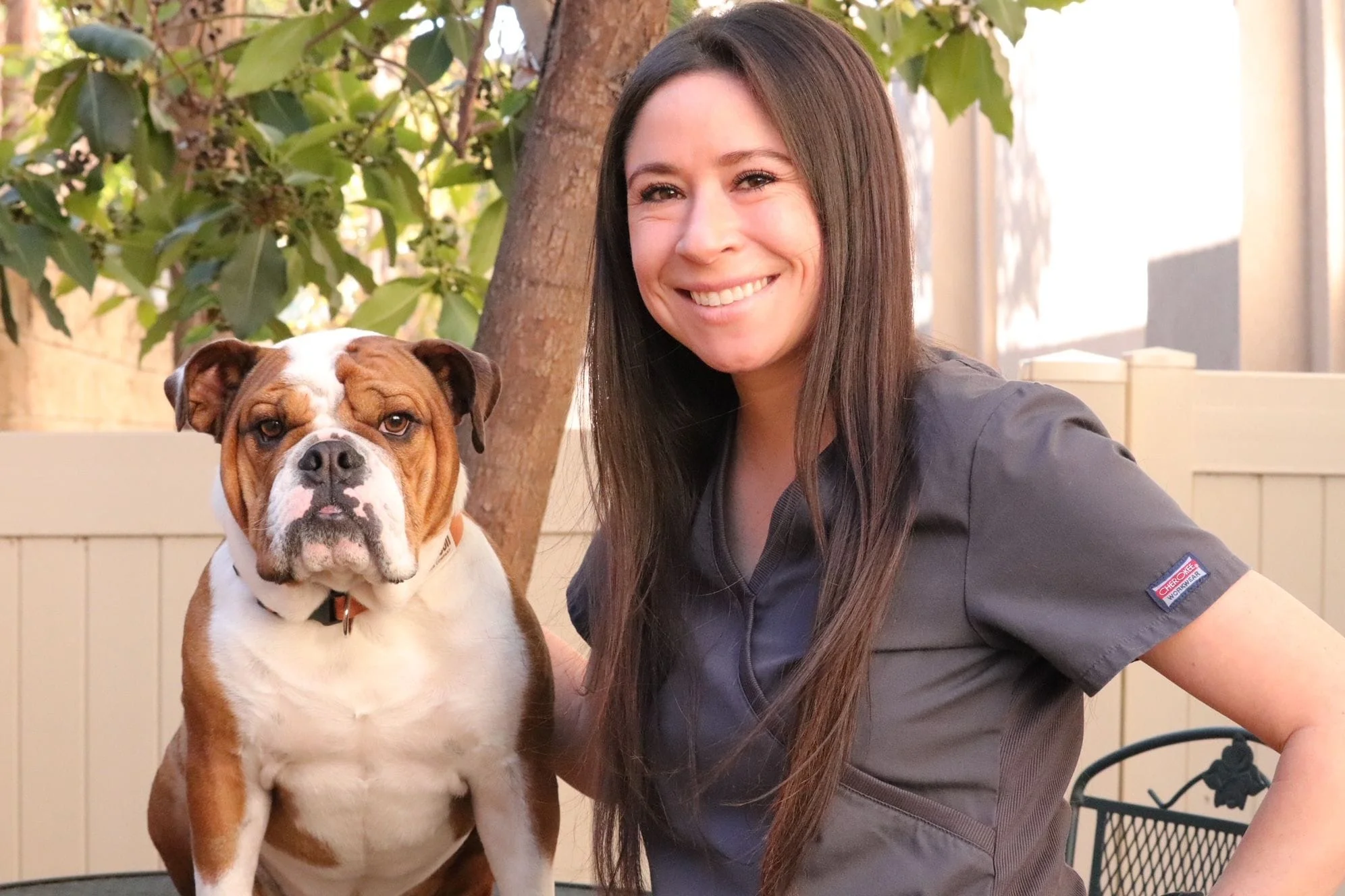 Girl with long black hair and bulldog