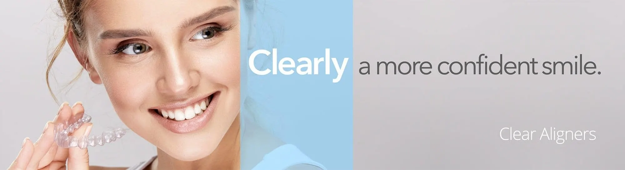 woman holding clear aligners
