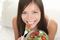Woman laughing eating healthy