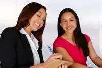 Young adult woman and teen smiling