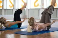 two woman doing yoga