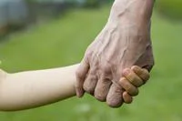 elderly hand holding adolescent hand