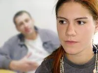 Upset Woman with Man in background