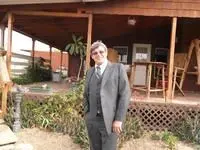 Dan Prine smiling in front of a porch