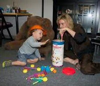 Adolescent psychotherapy. playing with a young boy with tinker toys.