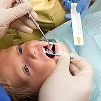 young blond boy getting flouride treatment applied to teeth, pediatric dentistry Melrose, MA