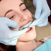 woman being fitted with custom nightguard from Pan Dental Care, family dentist Melrose, MA