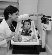 Shilpa Pankaj, MD, FAAP Weighing Baby On Table