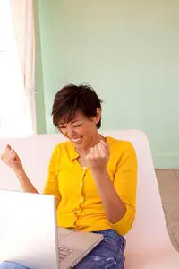 Happy woman in front of computer