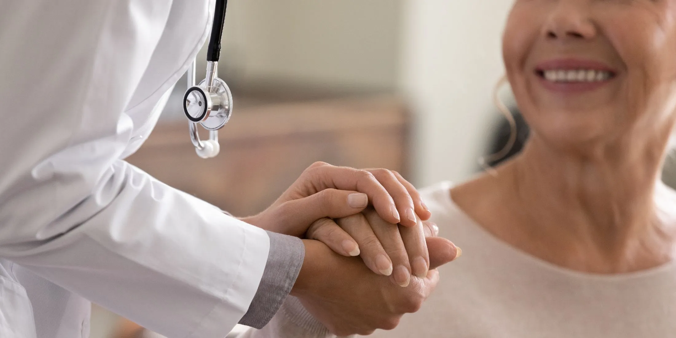 Provider meeting with older woman smiling