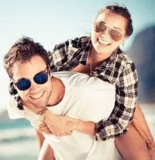 smiling couple wearing sunglasses