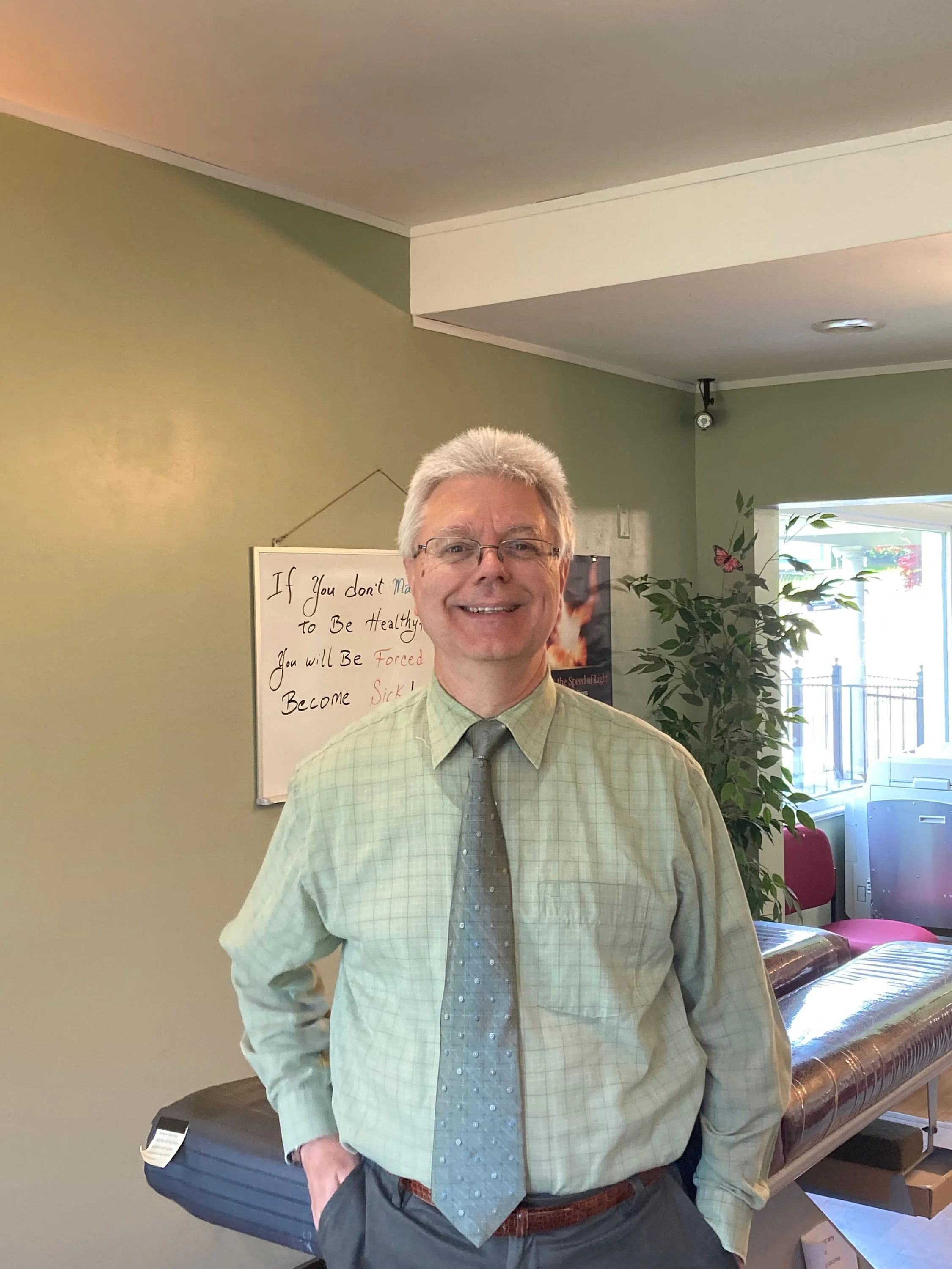Dr. Kish smiles in his office.