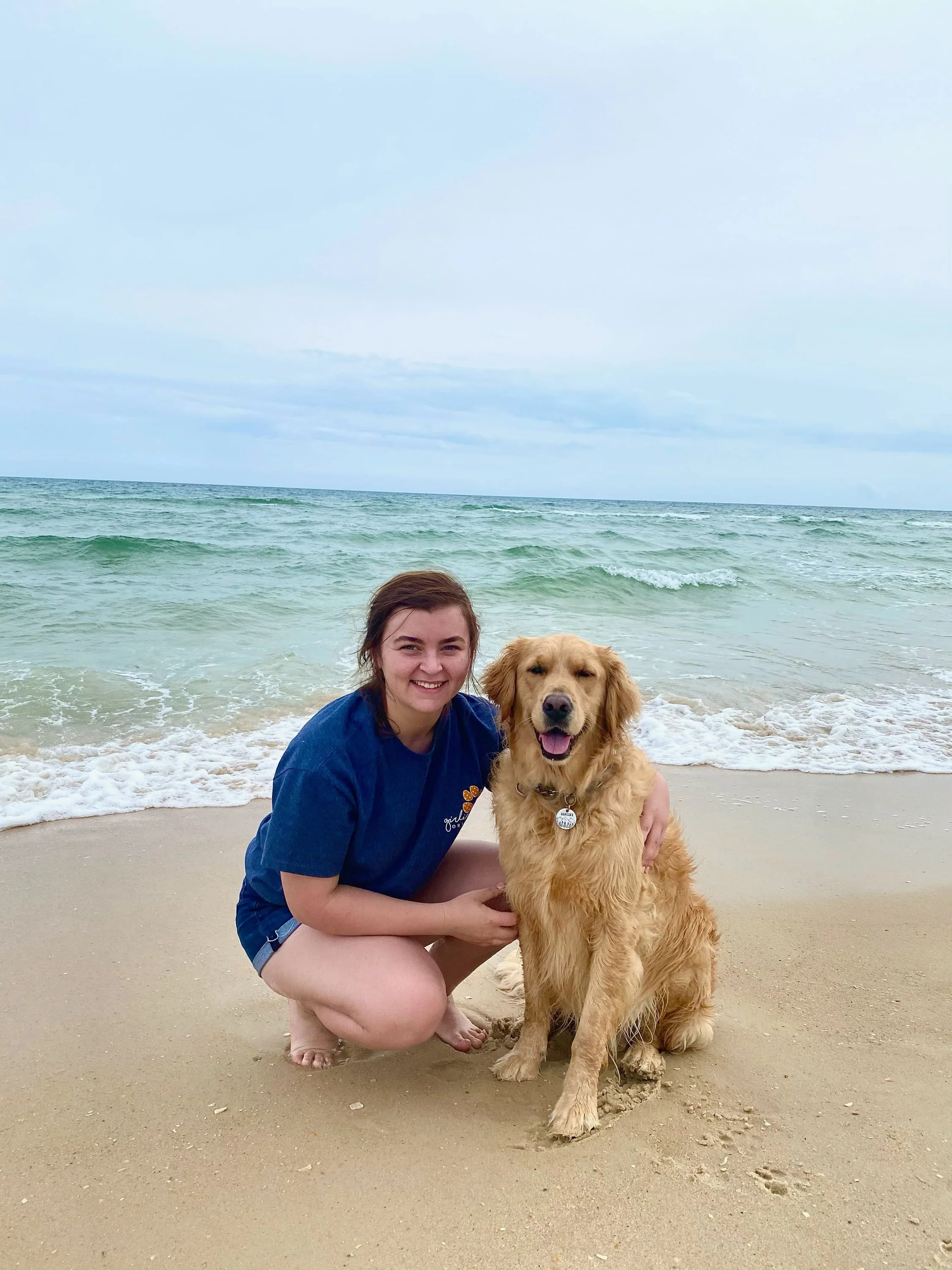 Devin and her golden retriever at the beach