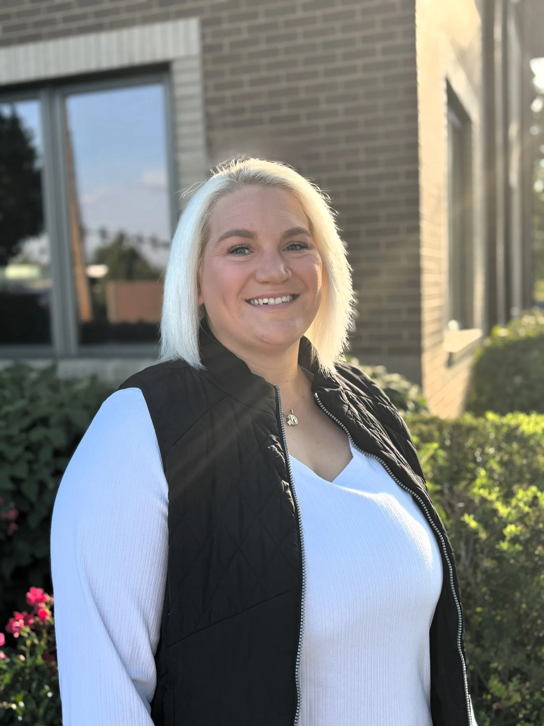 Photo of Whitney with the office building behind her
