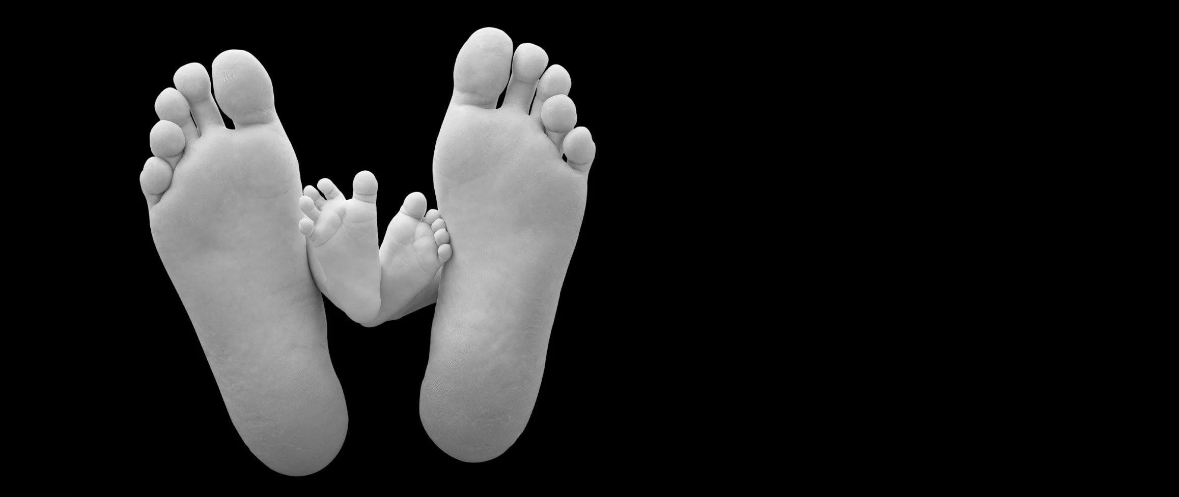 a child and adult foot interwoven