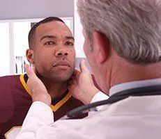 Chiropractor examining patient with possible concussion