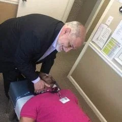 Dr. Pizza giving a chiropractic adjusmtent