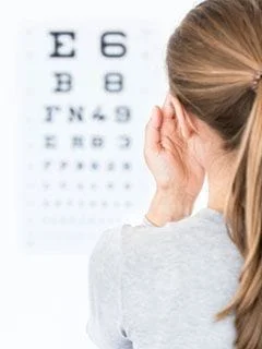 woman reading eye exam chart