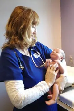 Staff holding infant at Pediatric Care North