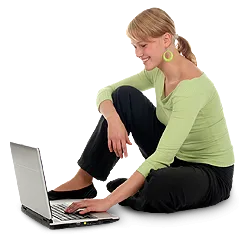 Woman seated on floor using laptop