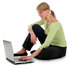 Woman using computer on the ground