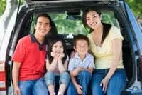 Smiling family in a car
