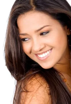 beautiful dark haired woman smiling looking left, nice white teeth, dental veneers Decatur, IL cosmetic dentistry 