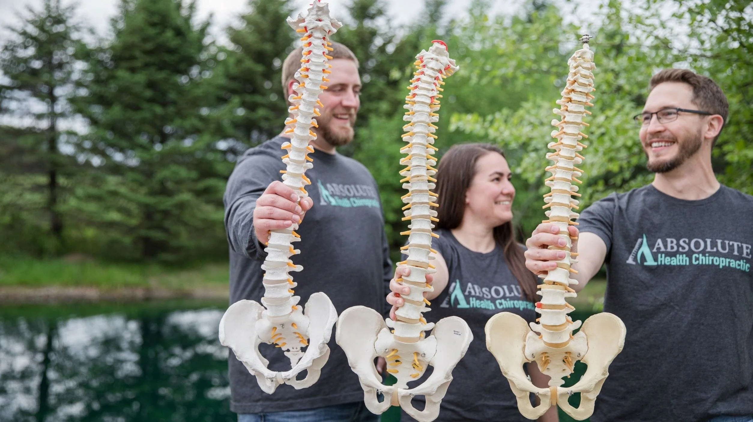 Chiropractors holding spines.